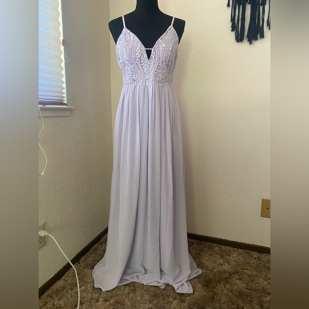 Lulu’s floor length lavender bridesmaids dress with spaghetti straps and lace.
